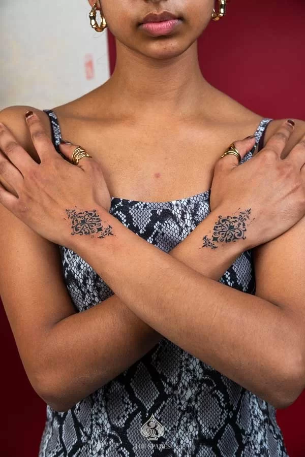 Ornamental Black Backhand Tattoo